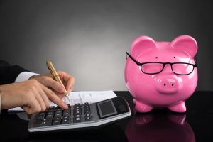 Businessperson-Calculating-Tax-At-Des